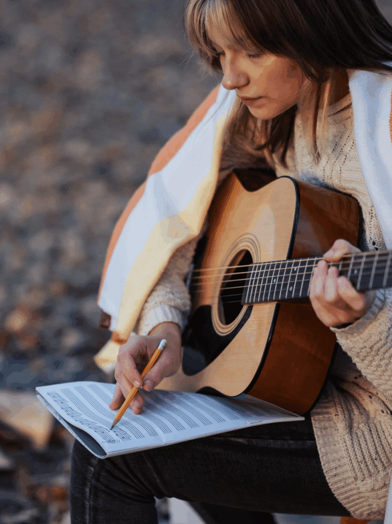 Woman Learning to Play a Song on Guitar